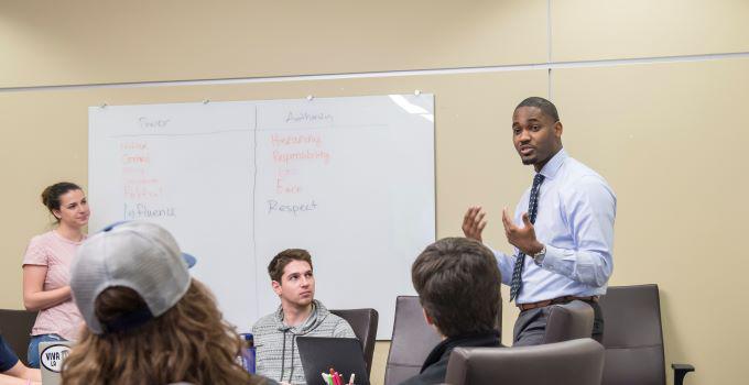 A male professor leads a classroom discussion.
